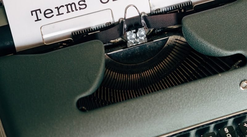 green and white typewriter with white paper